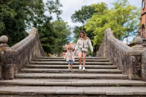 Child and adult walking over the Dell Bridge
