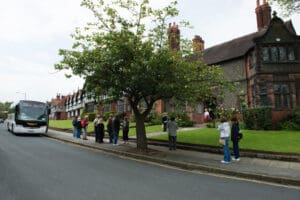 Coach dropping off group visit outside Bridge Cottage